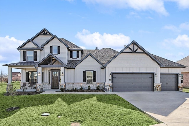 view of front facade featuring a garage, a front yard, and a porch