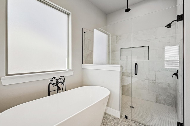 bathroom with plenty of natural light and separate shower and tub