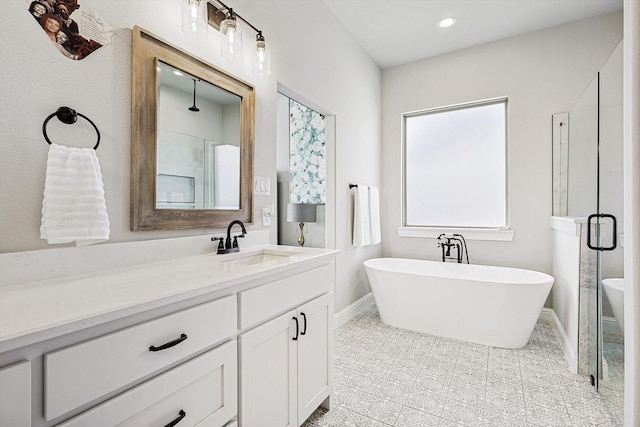 bathroom featuring vanity, a wealth of natural light, and plus walk in shower