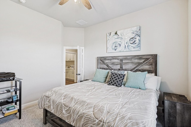 bedroom with ceiling fan, carpet, and ensuite bath