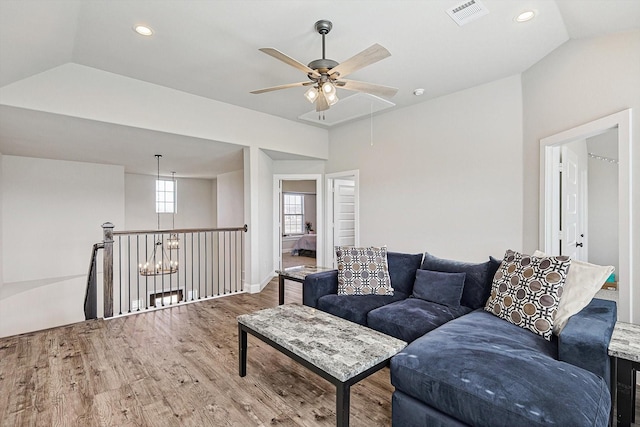 living room with ceiling fan, hardwood / wood-style flooring, and lofted ceiling