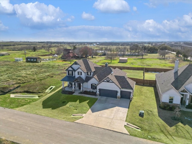 birds eye view of property featuring a rural view