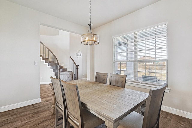 dining area featuring dark hardwood / wood-style floors and a notable chandelier