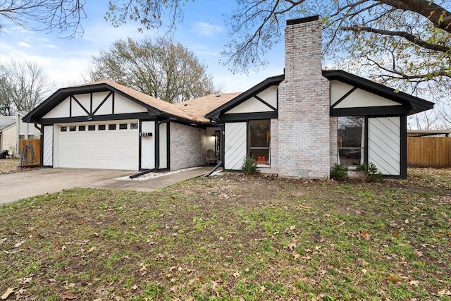 view of front of home with a garage and a front lawn