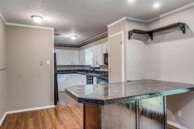 kitchen featuring white cabinets, black appliances, wood-type flooring, ornamental molding, and kitchen peninsula