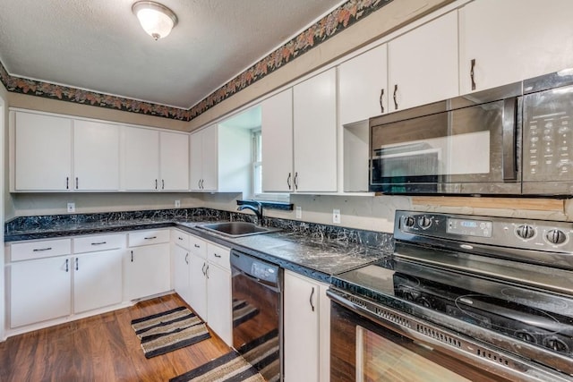 kitchen with a textured ceiling, white cabinets, black appliances, dark wood-type flooring, and sink