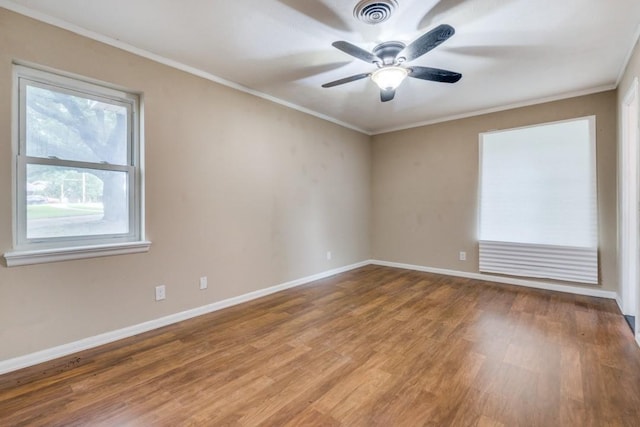 spare room with ceiling fan, ornamental molding, and wood-type flooring