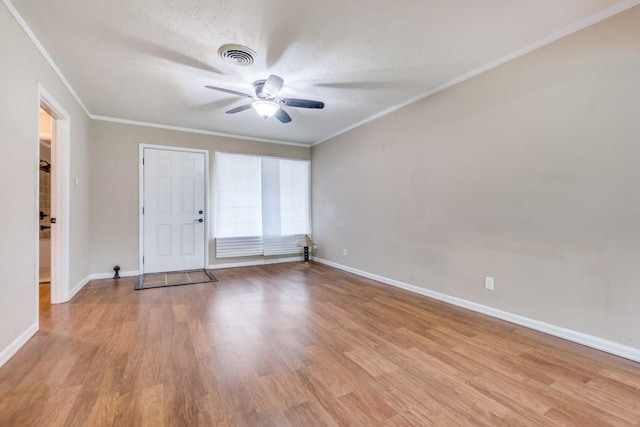 unfurnished room featuring a textured ceiling, ceiling fan, ornamental molding, and light hardwood / wood-style floors