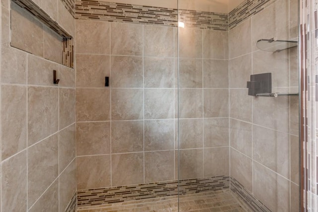 bathroom with tiled shower