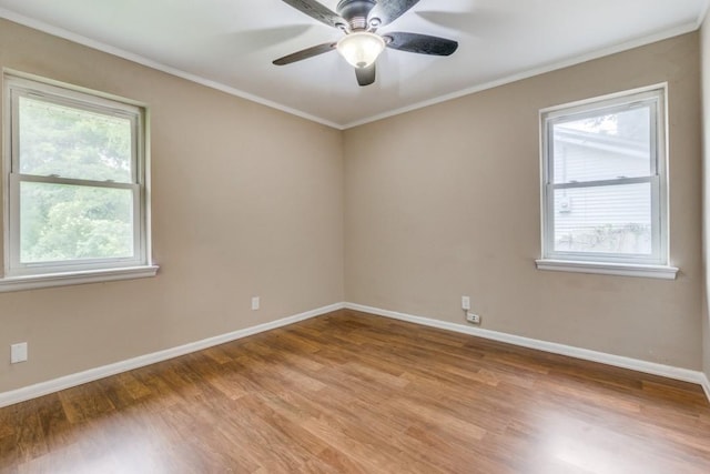 empty room with ceiling fan, ornamental molding, and light hardwood / wood-style floors