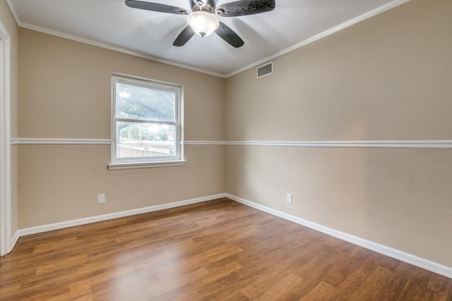 spare room with ceiling fan, hardwood / wood-style floors, and crown molding