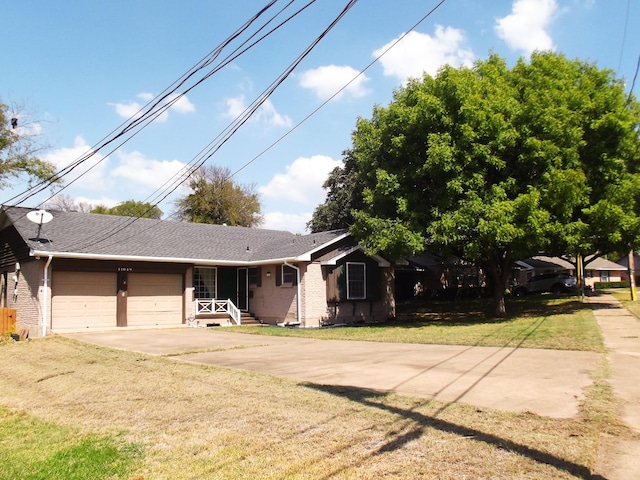 view of front of house featuring a garage and a front lawn