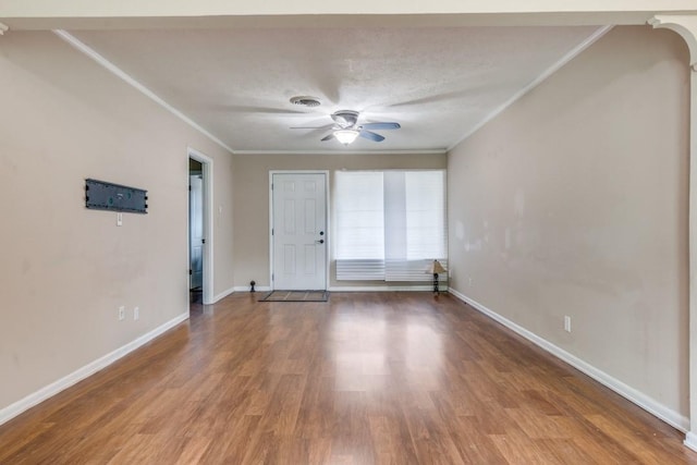 spare room with ceiling fan, a textured ceiling, ornamental molding, and hardwood / wood-style flooring