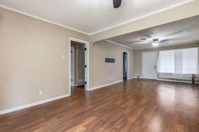 spare room featuring ceiling fan, dark hardwood / wood-style floors, and crown molding