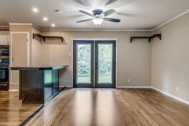 entryway with ceiling fan, french doors, crown molding, and wood-type flooring