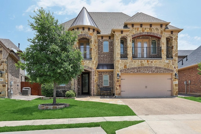 1776 Halifax St, Roanoke, TX 76262 - view of front of property with a balcony, stone siding, concrete driveway, an attached garage, and central air condition unit