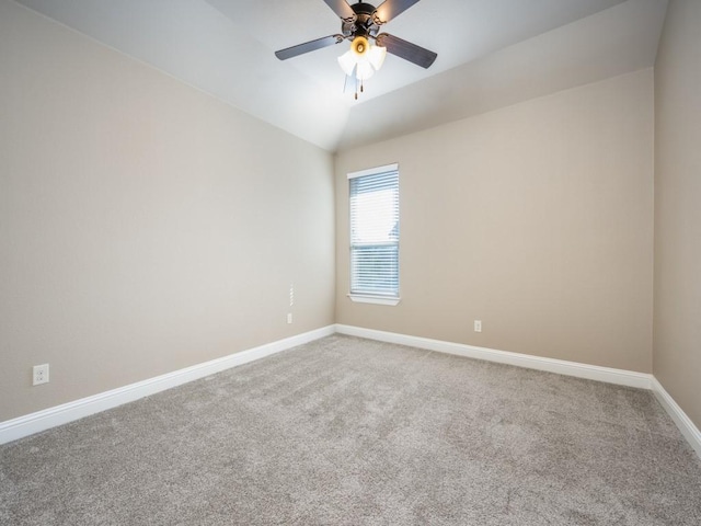 empty room with ceiling fan, lofted ceiling, and carpet floors