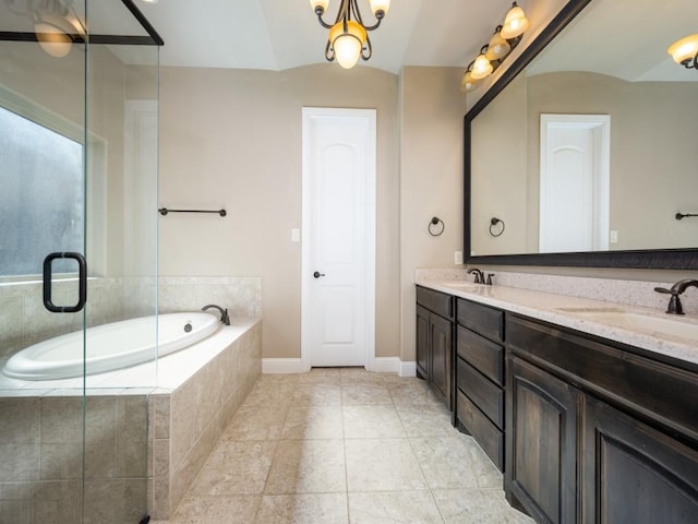 bathroom featuring vanity, vaulted ceiling, a notable chandelier, and tiled tub