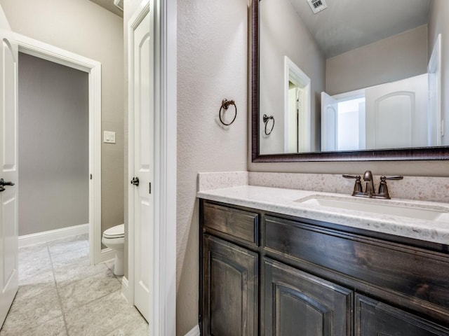 bathroom with toilet and vanity