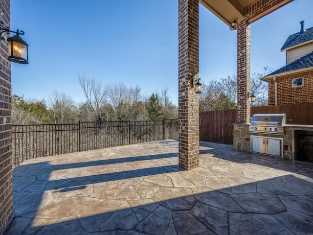 view of patio featuring a grill and an outdoor kitchen