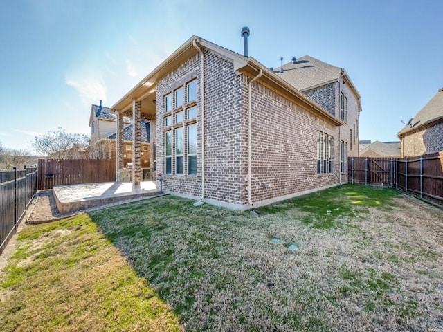 rear view of property featuring a yard and a patio