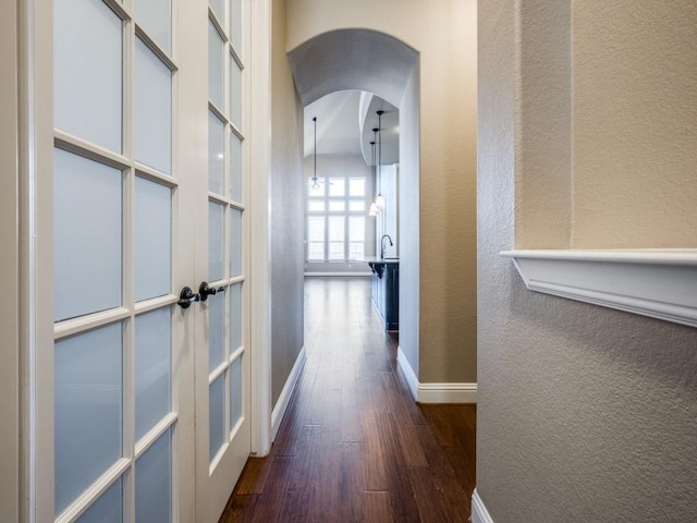 hallway with dark hardwood / wood-style flooring