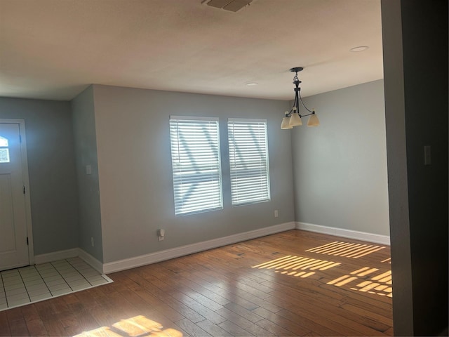 entryway with a notable chandelier and hardwood / wood-style floors