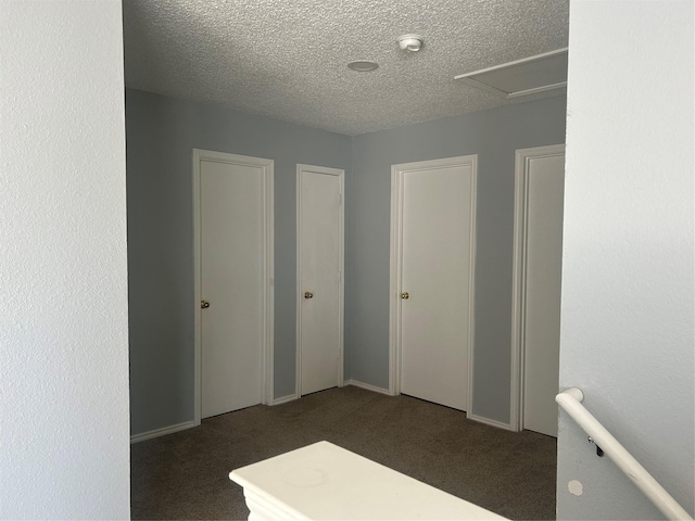 carpeted empty room with a textured ceiling