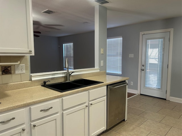 kitchen with ceiling fan, stainless steel dishwasher, sink, light tile patterned floors, and white cabinets