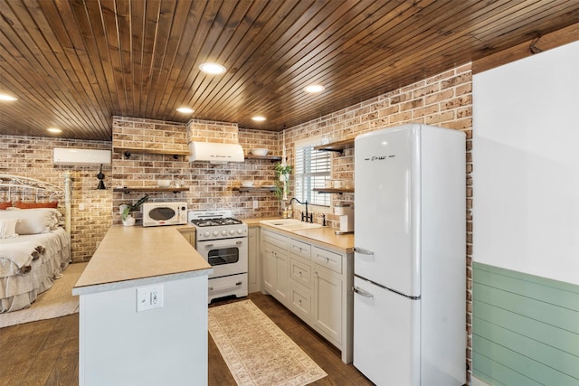 kitchen with open shelves, white appliances, wood ceiling, a sink, and brick wall