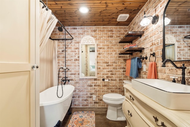 bathroom featuring a freestanding bath, wood ceiling, and brick wall