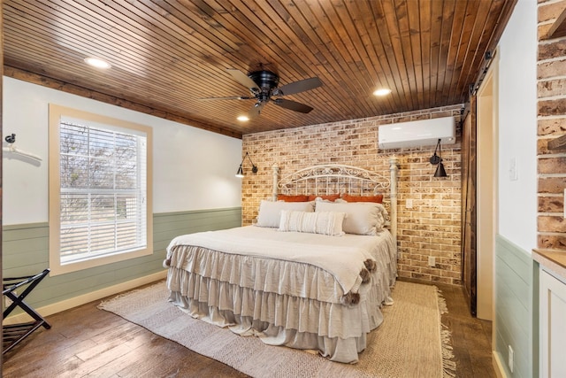 bedroom featuring ceiling fan, a wall mounted AC, brick wall, and hardwood / wood-style flooring