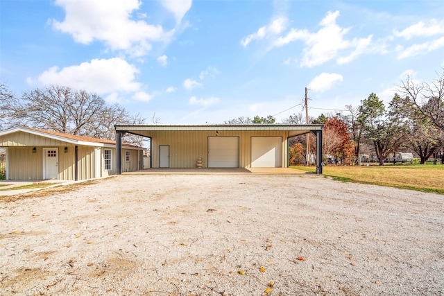 view of front of property with a front yard, a carport, and a garage