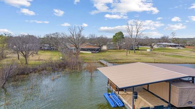 dock area with a lawn and a water view