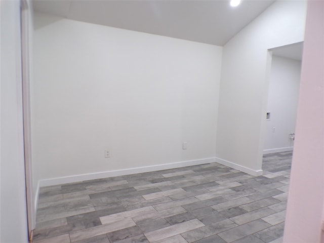 unfurnished room featuring lofted ceiling