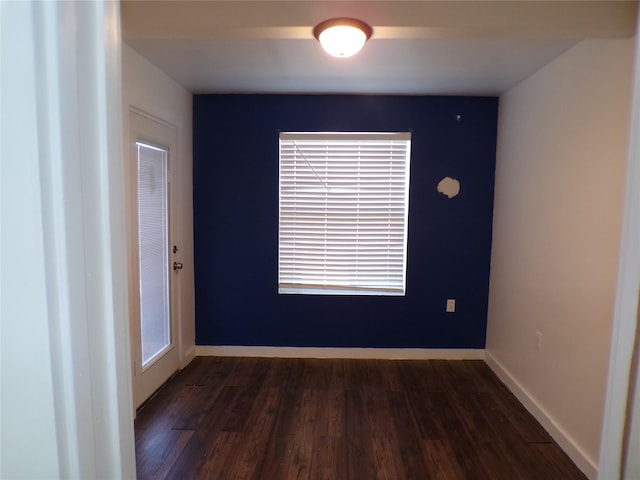 empty room featuring dark hardwood / wood-style flooring