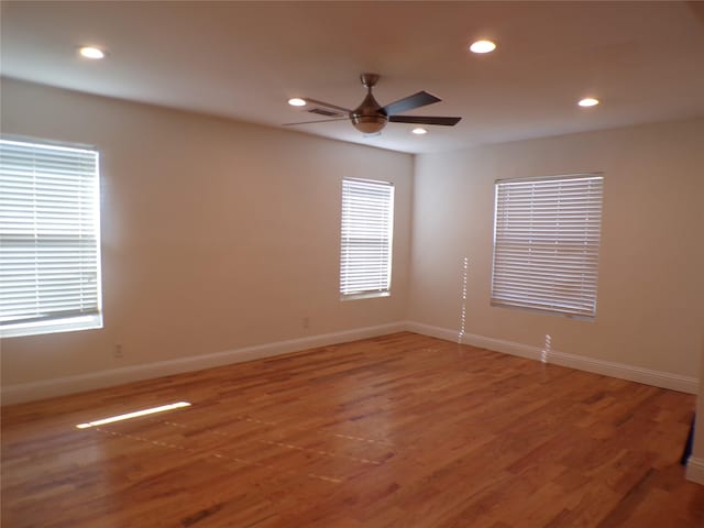 unfurnished room with ceiling fan and hardwood / wood-style floors