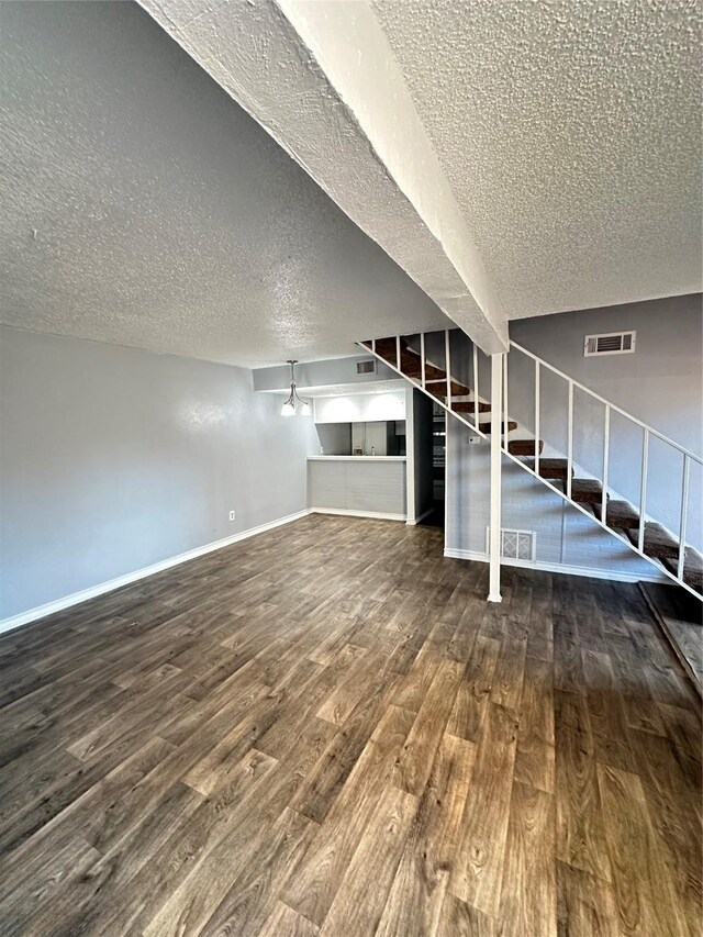 unfurnished living room with dark wood-type flooring