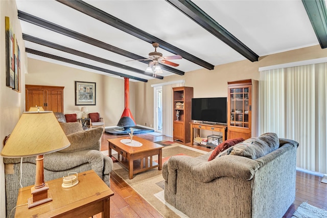 living room featuring ceiling fan, plenty of natural light, and vaulted ceiling with beams