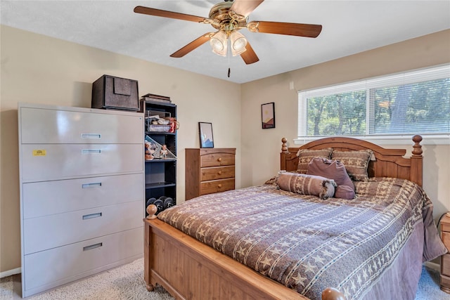 bedroom with ceiling fan and light carpet