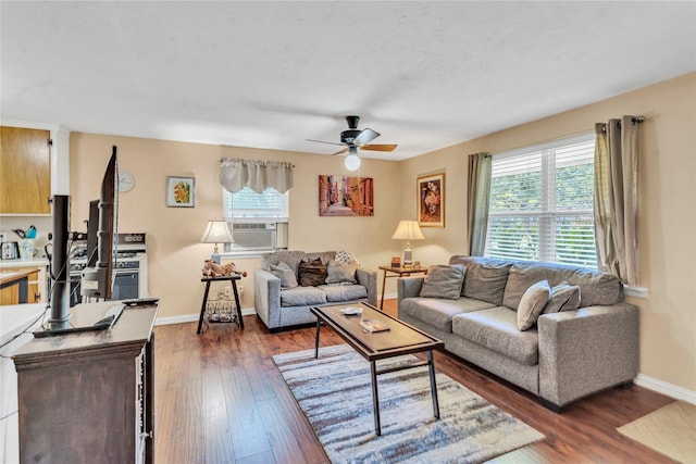 living room featuring ceiling fan and dark wood-type flooring