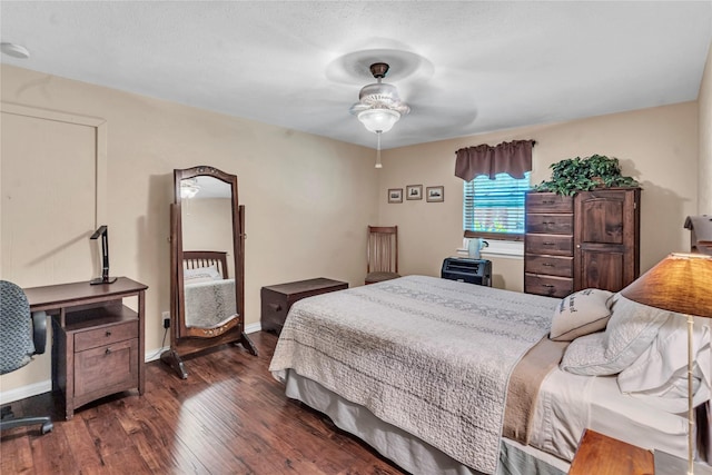 bedroom with ceiling fan and dark hardwood / wood-style flooring