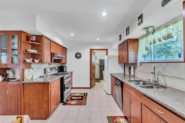 kitchen with dishwasher, sink, backsplash, light tile patterned flooring, and gas range