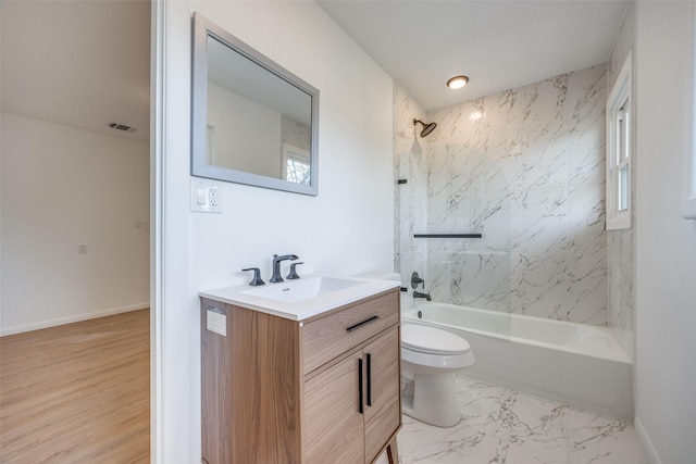 full bathroom with toilet, tiled shower / bath combo, and vanity