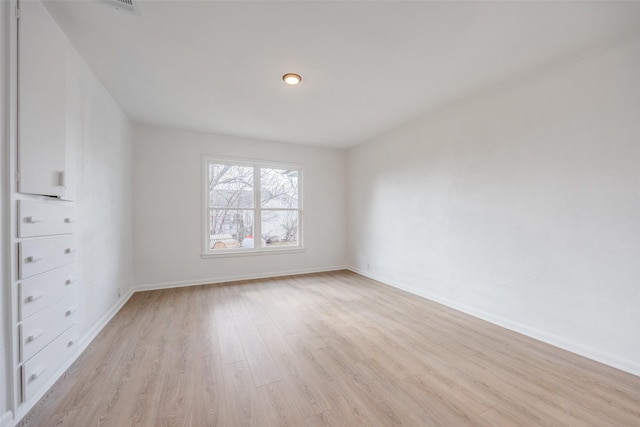 spare room with light hardwood / wood-style floors