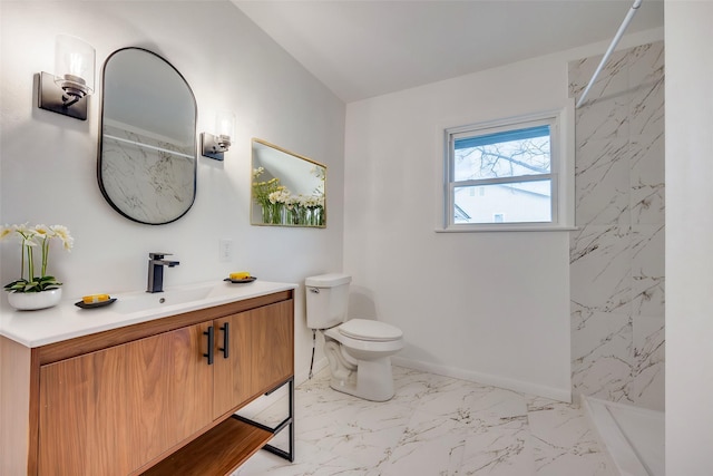 bathroom with toilet, vanity, and a shower