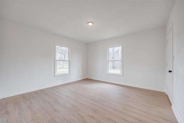 unfurnished room with light wood-type flooring