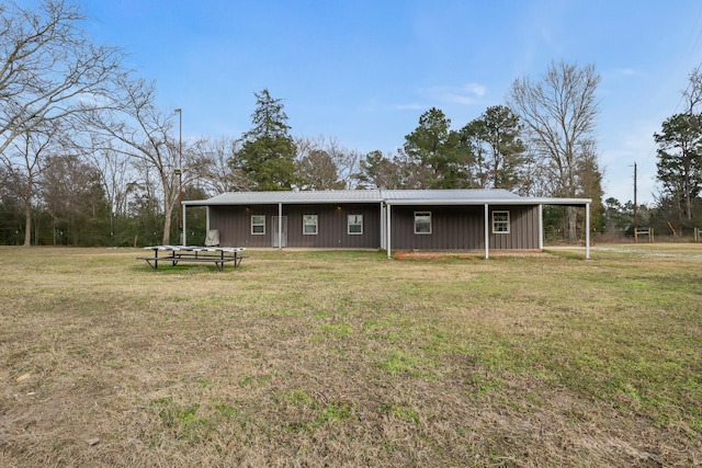 back of property with a lawn