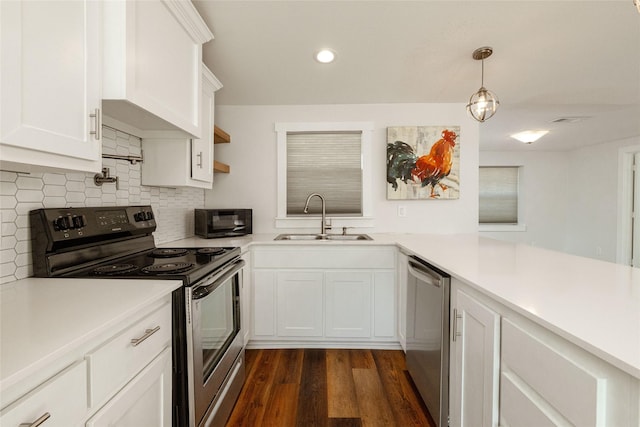 kitchen featuring stainless steel appliances, decorative backsplash, pendant lighting, white cabinets, and sink