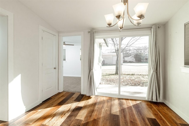 doorway to outside featuring an inviting chandelier and hardwood / wood-style flooring